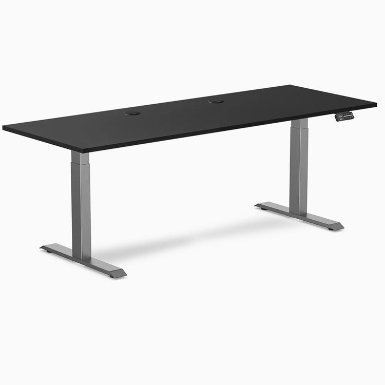 Black Desky Dual Laminate Sit Stand Desk, 78.7 x 29.5 inches, with grommets and Space Gray frame.