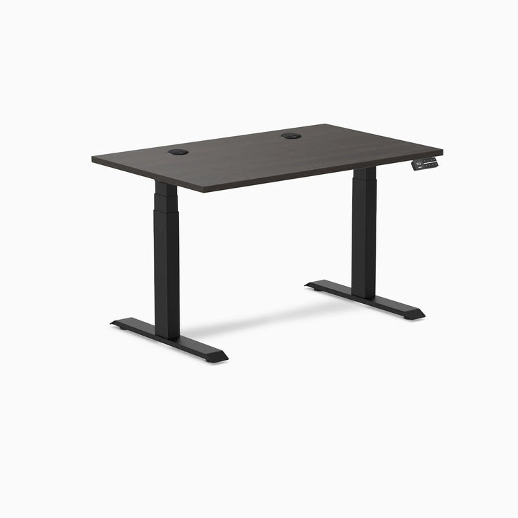 Desky Dual sit-stand desk with burnished wood laminate top, two grommets, and matte black frame.