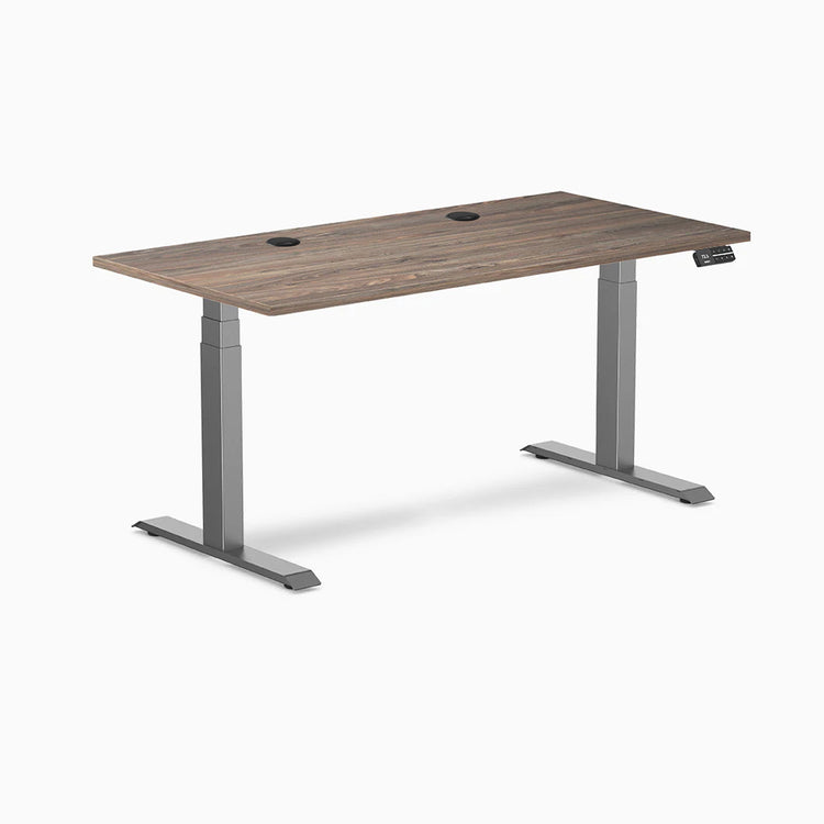 Desky Dual Laminate Sit Stand Desk with Natural Walnut top, Space Gray frame, and grommets.