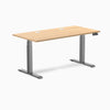 Desky Dual sit-stand desk with Sublime Teak laminate top, two grommets, and Space Gray frame.