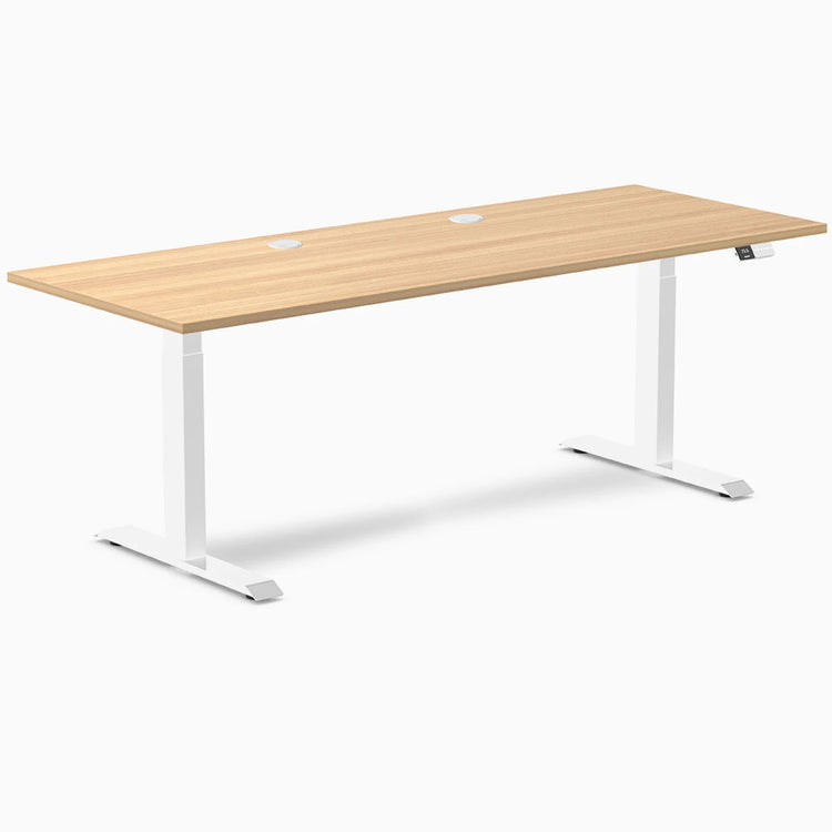 Desky Dual Laminate Sit Stand Desk in Sublime Teak, 78.7 x 29.5 inches, with white frame and grommets.