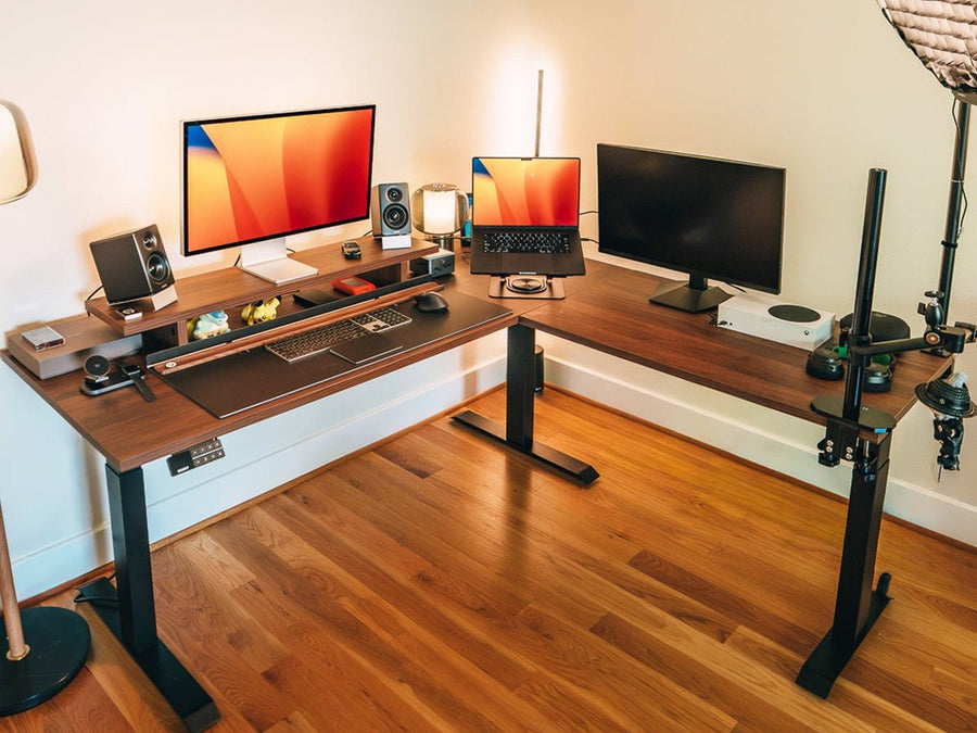Desky L-Shape Sit Stand Desk in Jarrah Legno in a corner home office