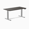 Dark laminate Desky Dual sit-stand desk with silver frame and digital control panel.