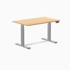 Desky Dual Custom Laminate Sit Stand Desk with natural wood-look top and silver adjustable legs.