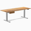 Teak hardwood standing desk, 80x30 inches, with gray legs and matching under-desk drawer.