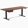 Walnut hardwood standing desk with matte black legs and integrated drawer.