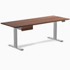 Walnut hardwood standing desk with gray legs and matching under-desk drawer.