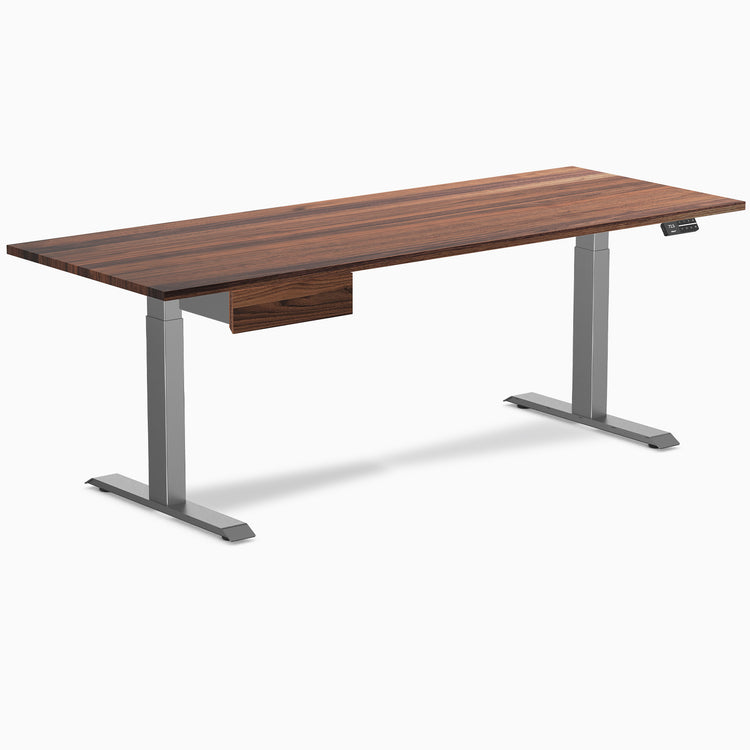Walnut hardwood standing desk with a matching drawer and space gray legs.