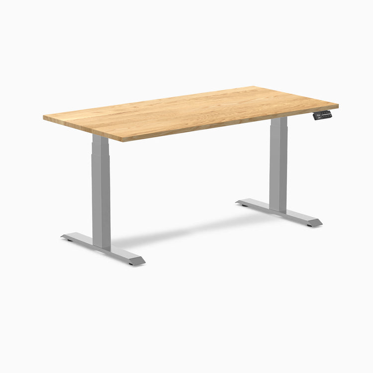 Desky Dual 60x30 inch White Oak hardwood sit-stand desk with gray legs and control panel.