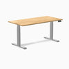 Desky Dual 60x30 inch White Oak hardwood sit-stand desk with gray legs and control panel.