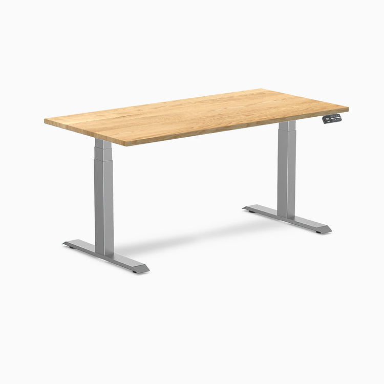 Desky Dual 60x30 inch White Oak hardwood sit-stand desk with Space Gray legs and control panel.