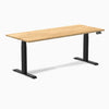 Desky Dual Hardwood Sit Stand Desk with a White Oak top and Matte Black legs.