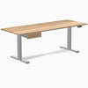 Desky Dual hardwood standing desk, white oak top, gray legs, and matching under-desk drawer.