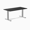 Desky Zero fixed height office desk with black laminate top and silver steel frame.