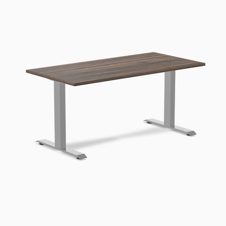 Desky Zero fixed height office desk with dark wood laminate top and silver steel frame.