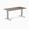 Desky Zero laminate office desk with a dark wood grain top and silver steel frame.