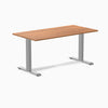 Desky Zero fixed height office desk with a natural wood laminate top and silver steel frame.