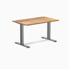 Desky Zero ergonomic office desk with Teak hardwood top and Space Gray steel frame.