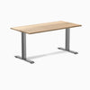 Desky Zero fixed-height office desk with a White Ash hardwood top and Space Gray steel frame.
