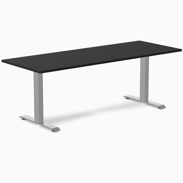 Desky Zero fixed height office desk with a black laminate top and silver steel T-frame legs.