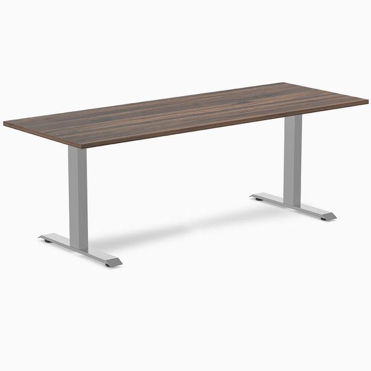 Desky Zero laminate office desk with a dark wood grain top and silver steel frame.