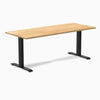 Desky Zero fixed-height office desk with a White Oak hardwood top and matte black steel frame.